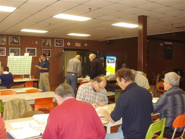 Rotarians taking bids and keeping track of winners.